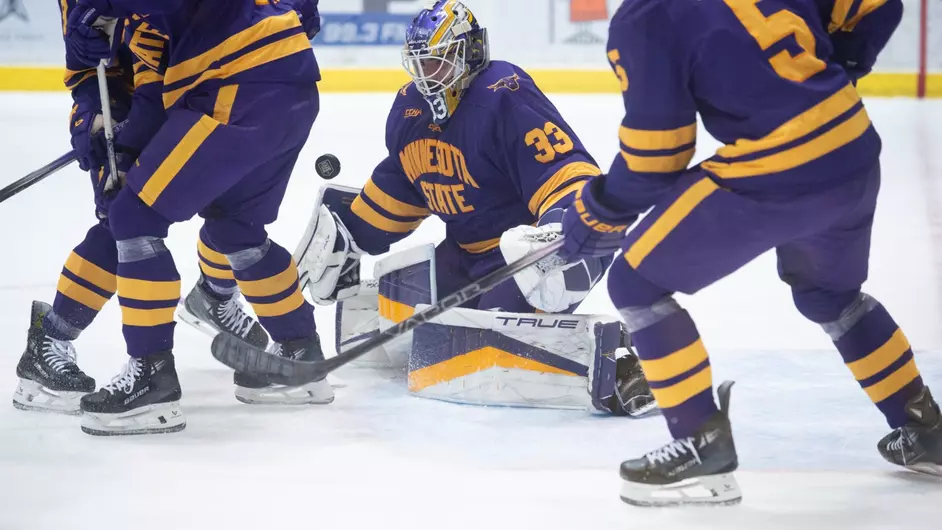 Minnesota State junior goaltender Alex Tracy stopping a shot.