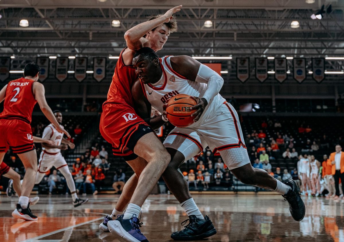 Bowling Green, OH – Falcons senior forward Marcus Johnson (6) battling towards the hoop against a Wildcat defender at the Stroh Center in Bowling Green, Ohio