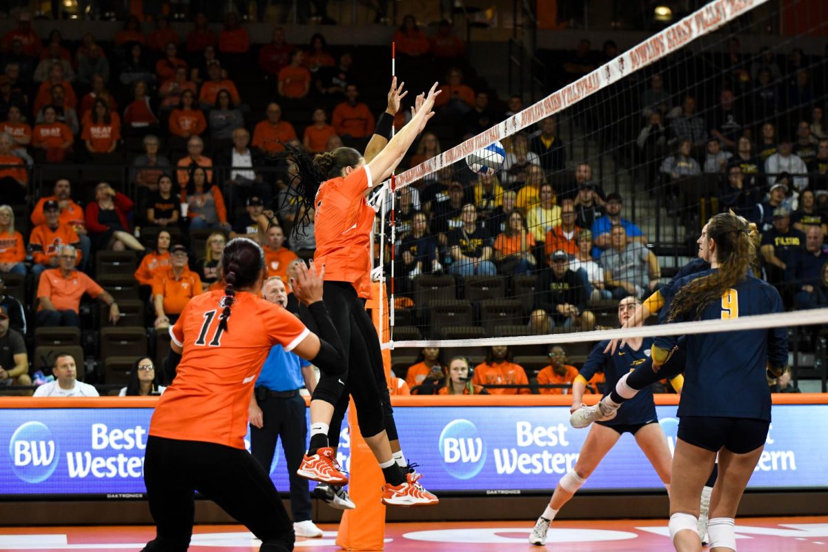 Bowing Green, OH - Falcons senior outside hitter Mia Tyler (9) and junior middle blocker Jessica Andrews (7) shutting down the Rockets attack at the Stroh Center in Bowling Green, Ohio.