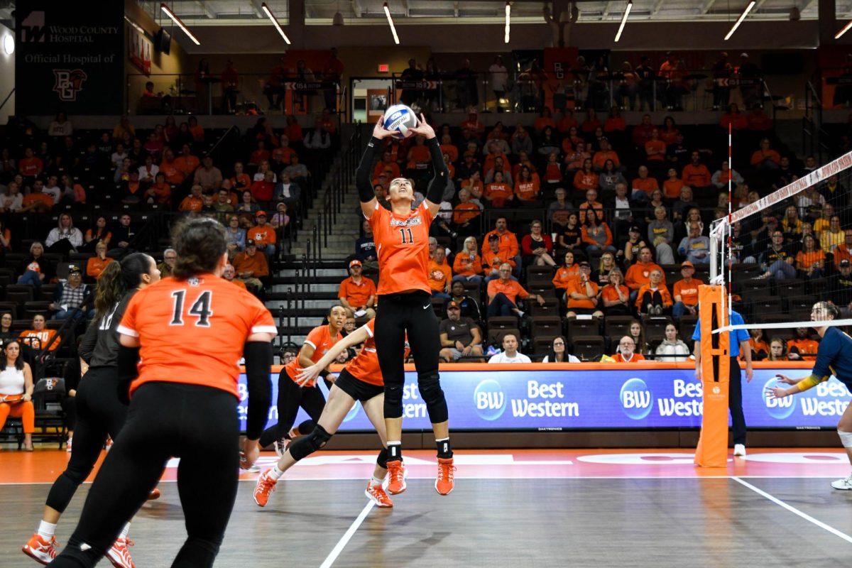 Bowling Green, OH - Falcons sophomore setter Amanda Otten (11) setting an attack for the Falcons at the Stroh Center in Bowling Green, Ohio.
