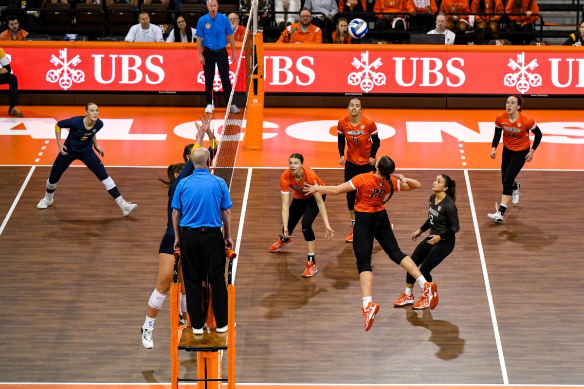 Bowling Green, OH - Falcons redshirt freshman outside hitter Edyta Waclawczyk (20) hitting through the Rockets blockers at the Stroh Center in Bowling Green, Ohio.
