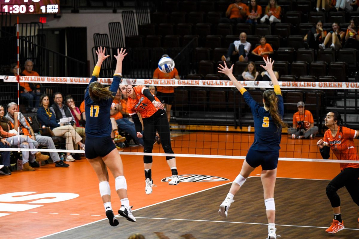 Bowling Green, OH - Falcons junior opposite Lauren Hovey (14) hitting through the Rockets blockers at the Stroh Center in Bowling Green, Ohio.
