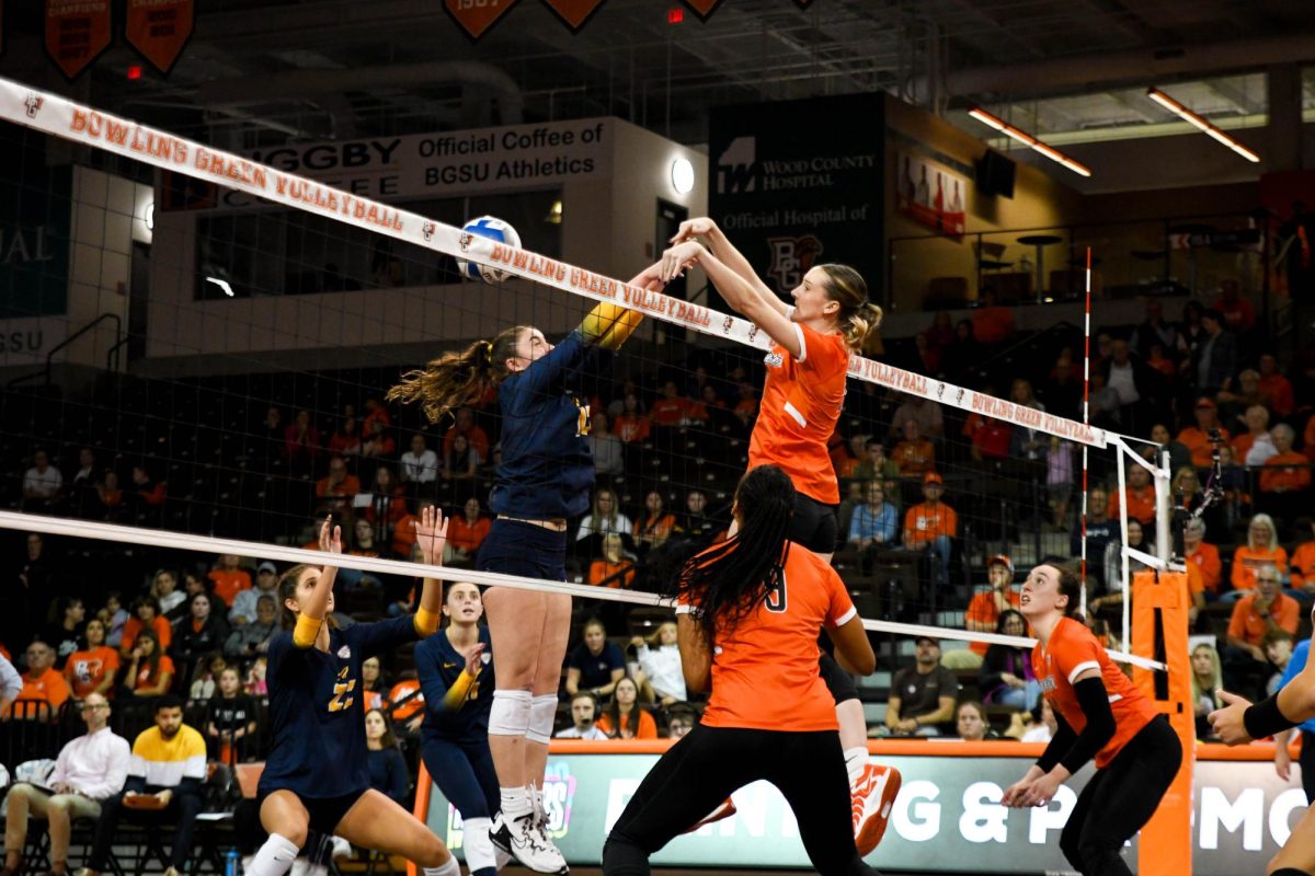 Bowling Green, OH - Falcons fifth year middle blocker Alexis Mettille (16) tipping the ball past the Rockets blockers at the Stroh Center in Bowling Green, Ohio.
