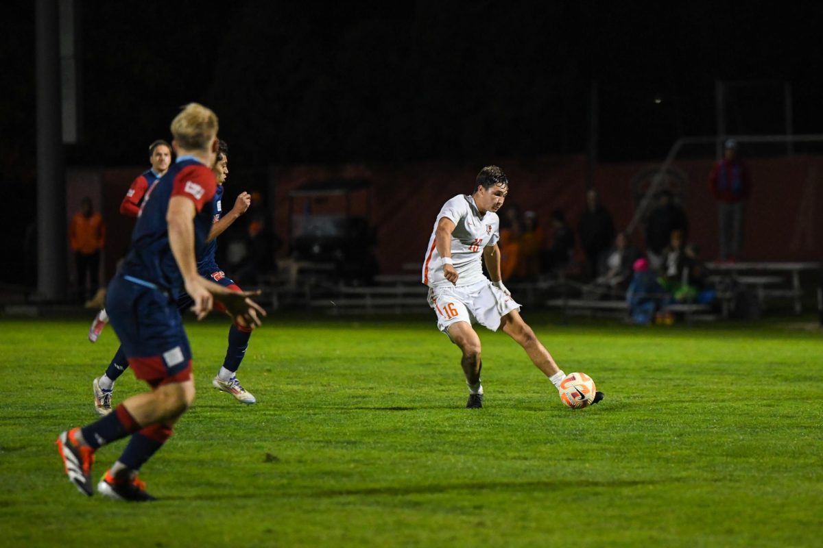 Bowling Green, OH - Falcons sophomore midfielder Jake Lane (16) passing through the Flames defense at Cochrane Stadium in Bowling Green, Ohio.