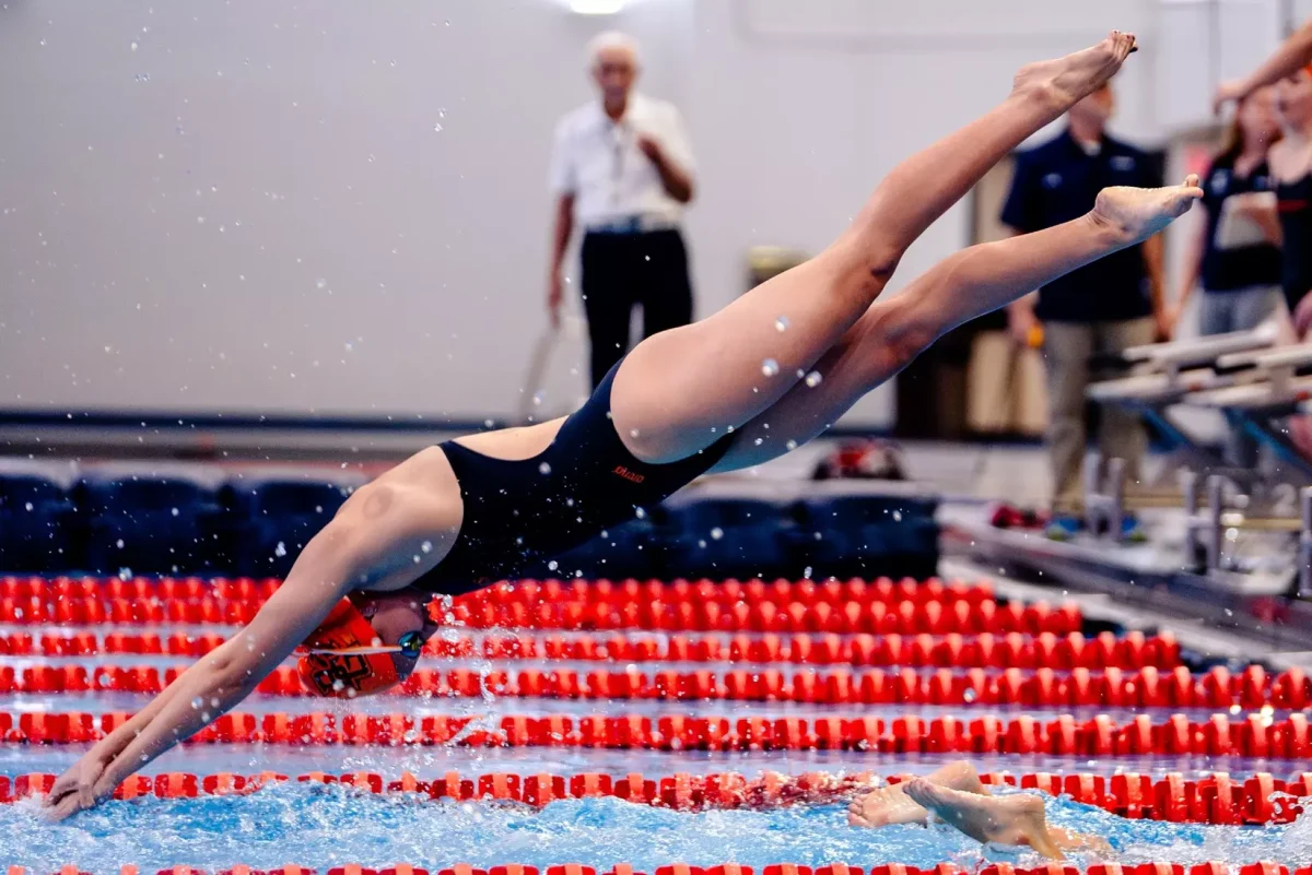 Freshman Kalina Solera dives into the pool.