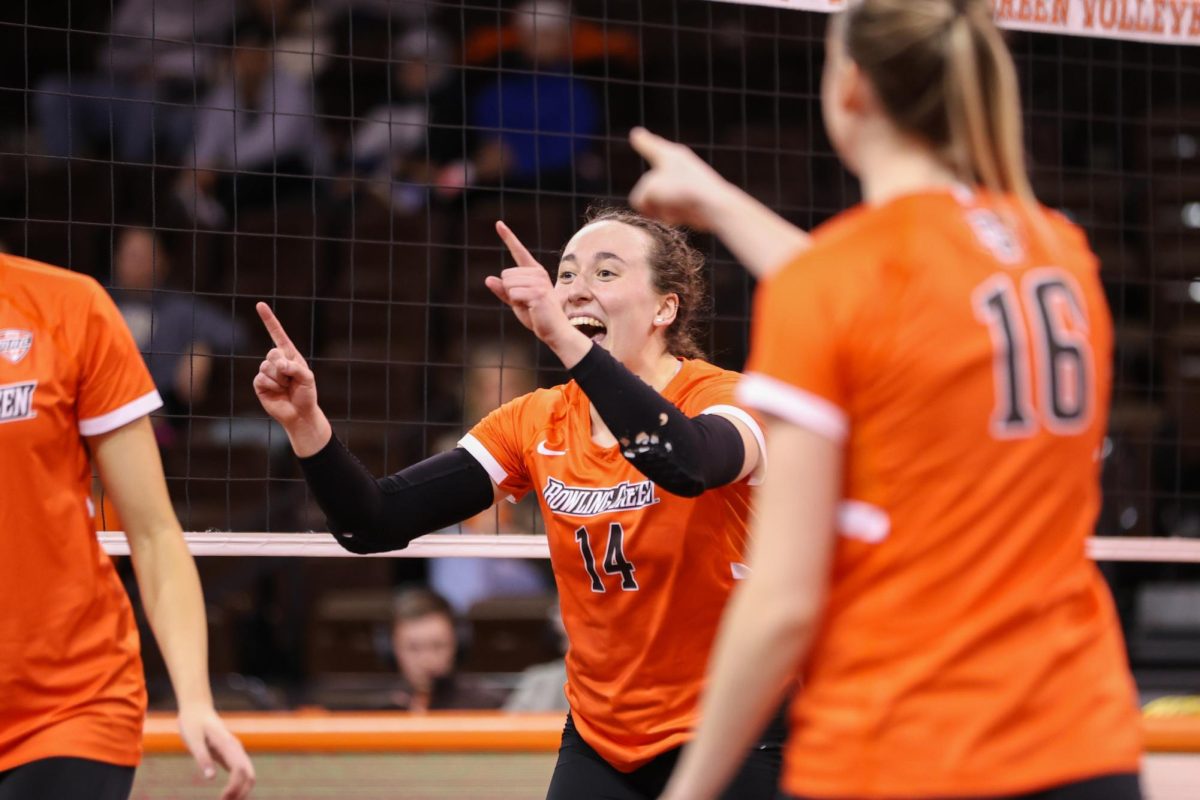 Bowling Green, OH - Falcons junior opposite Lauryn Hovey (14) celebrates scoring a point against the Bearcats at the Stroh Center in Bowling Green, Ohio.