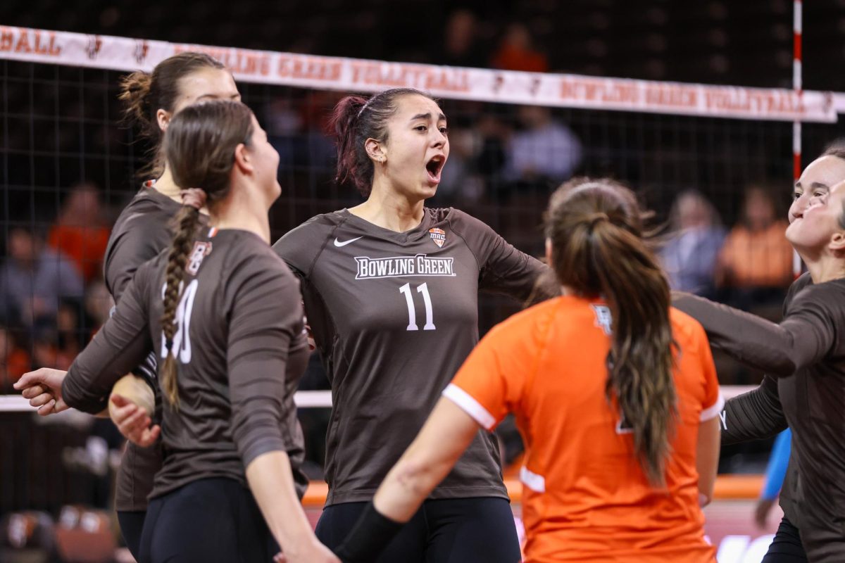 Bowling Green, OH - Falcons sophomore right side setter Amanda Otten (11) celebrates while playing the Wright State Raiders at the Stroh Center in Bowling Green, Ohio.