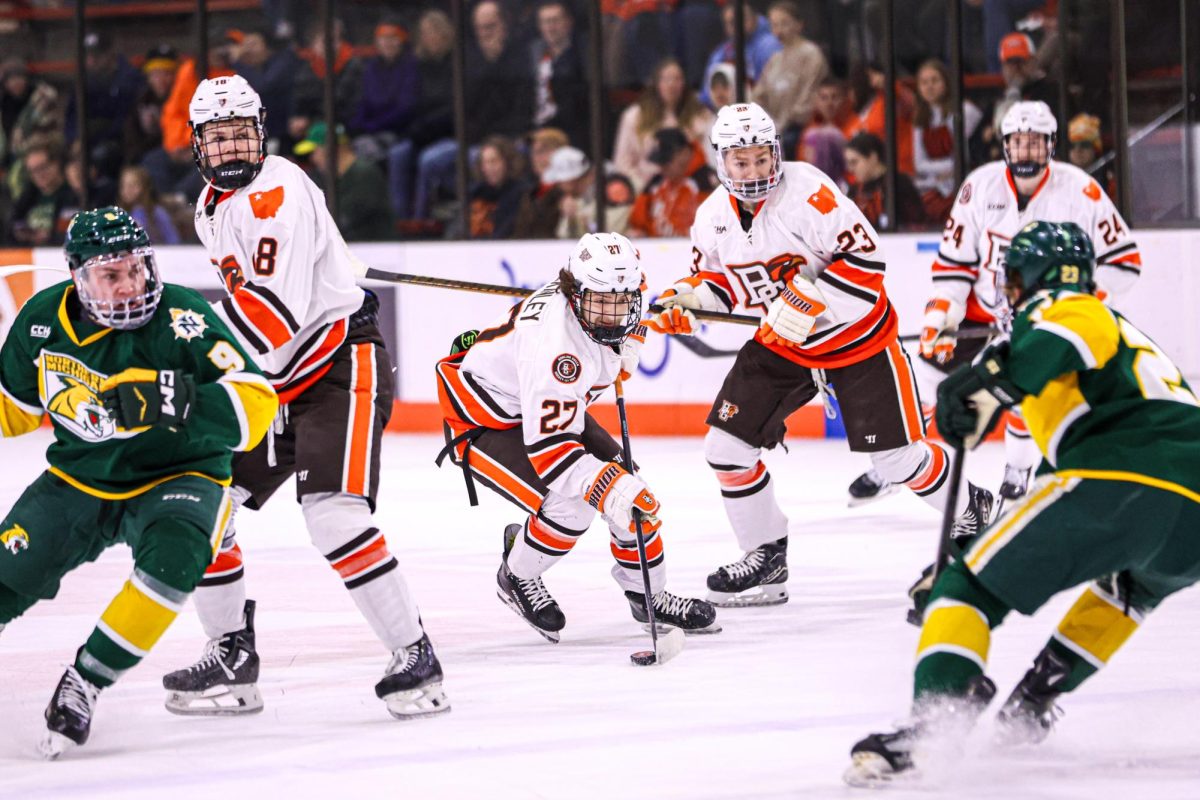 Bowling Green, OH - Falcons sophomore defenseman Breck McKinley (27) skates down the ice with the puck against the Wildcats at the Slater Family Ice Arena in Bowling Green, Ohio.