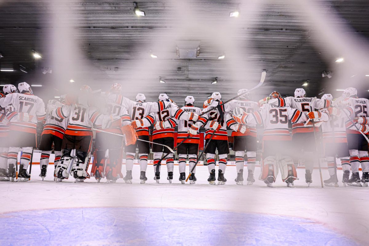 Bowling Green, OH - The Falcons hockey team sings the Alma Mater following a win over the Northern Michigan Wildcats at the Slater Family Ice Arena in Bowling Green, Ohio.