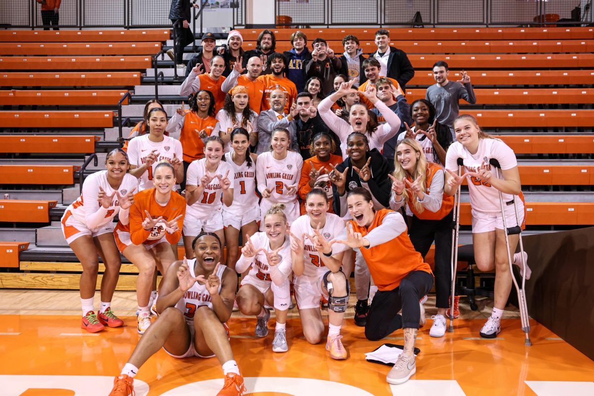 Bowling Green, OH - The BGSU women's basketball team pose with the Falcons student section after defeating the Marquette University Golden Eagles at the Stroh Center in Bowling Green, Ohio.