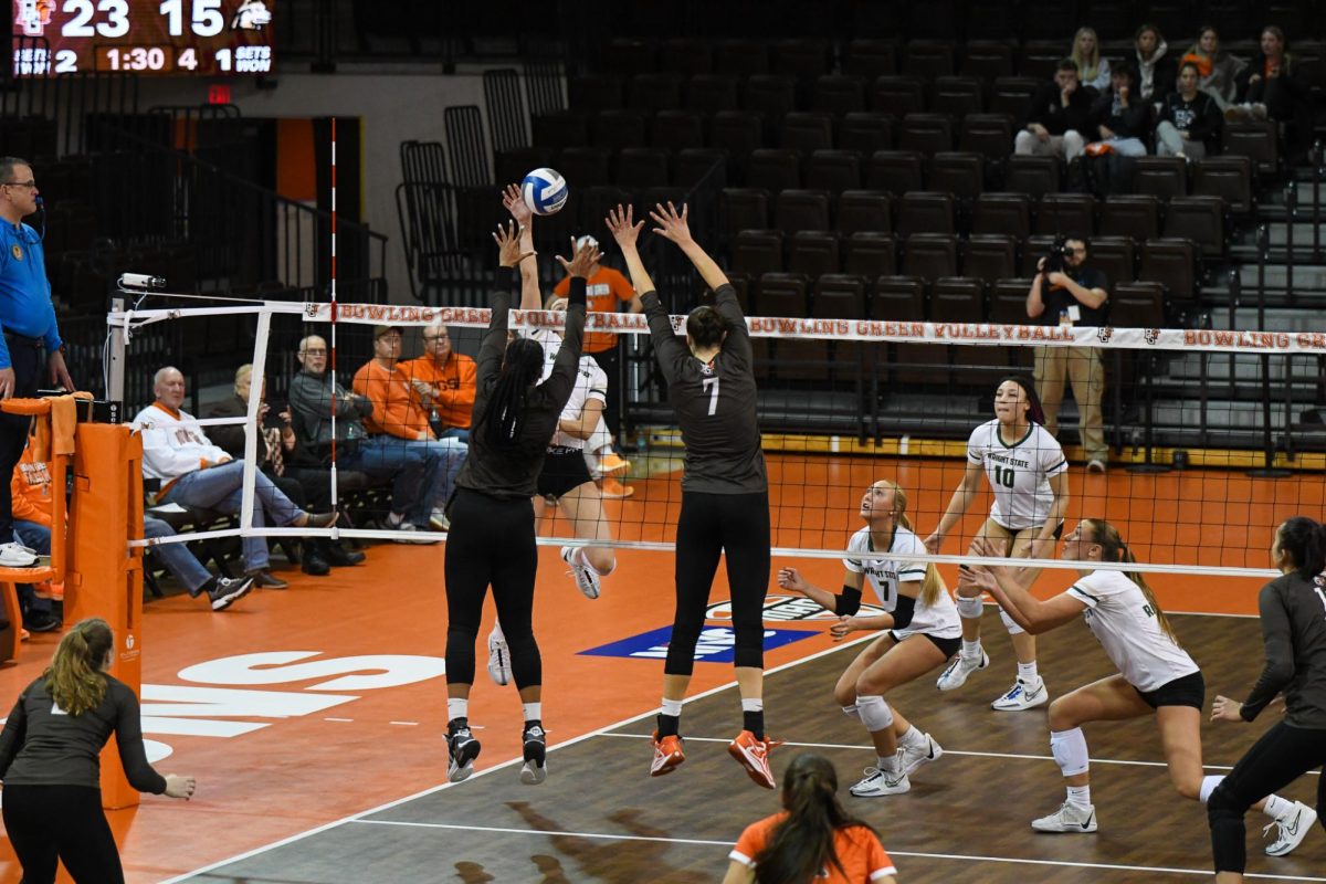 Bowling Green, OH - Falcons senior outside hitter Mia Tyler (9) and junior middle blocker Jessica Andrews (7) closing down a block at the Stroh Center in Bowling Green, Ohio.