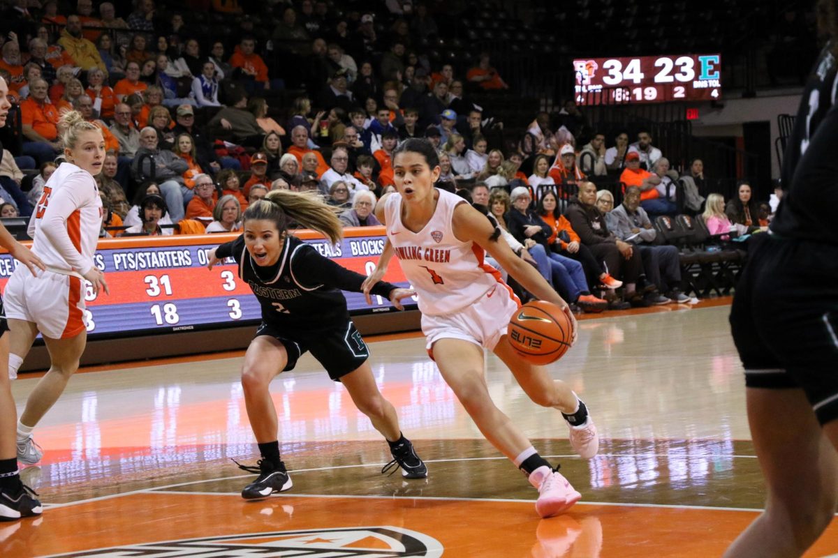 Bowling Green, OH - Falcons senior guard Amy Velasco (1) driving around an Eastern Michigan defender to get to the hoop at the Stroh Center in Bowling Green, Ohio.