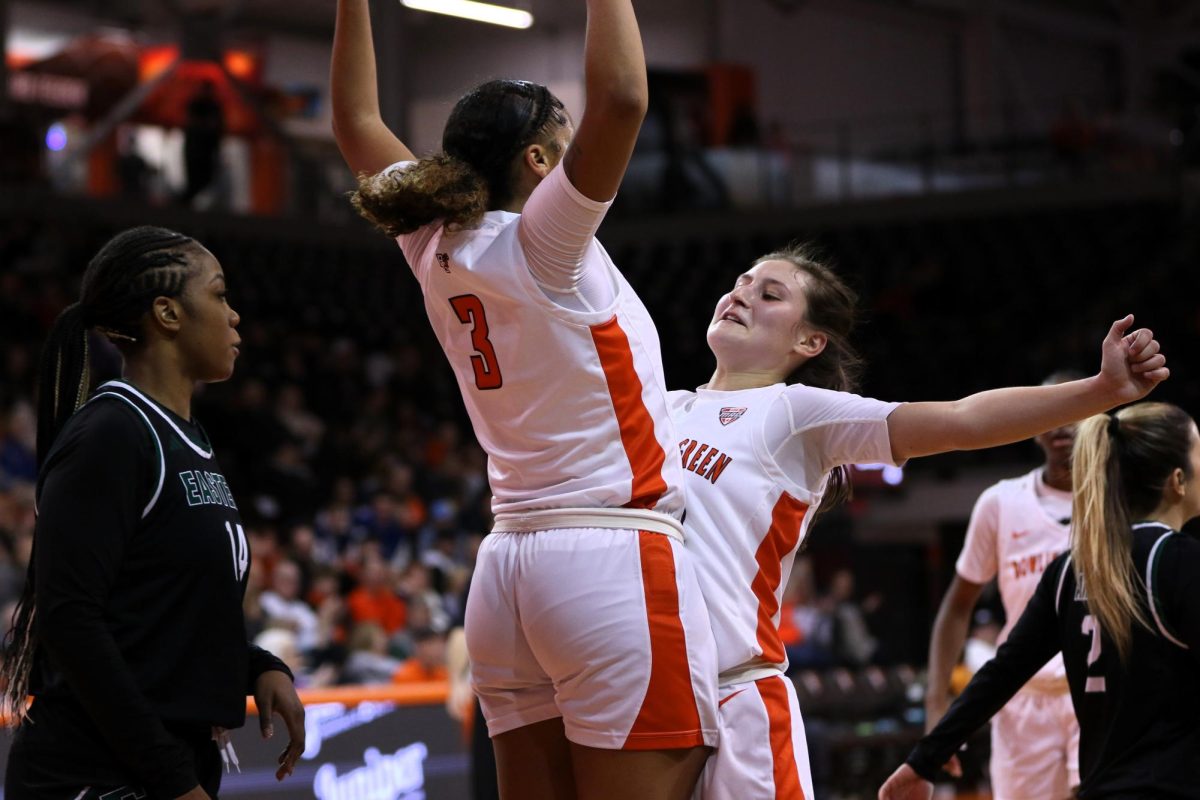 Bowling Green, OH - Falcons freshman guard Johnea Donahue (3) and sophomore guard Paige Kohler (10) celebrating after making a bit play late in the game at the Stroh Center in Bowling Green, Ohio.