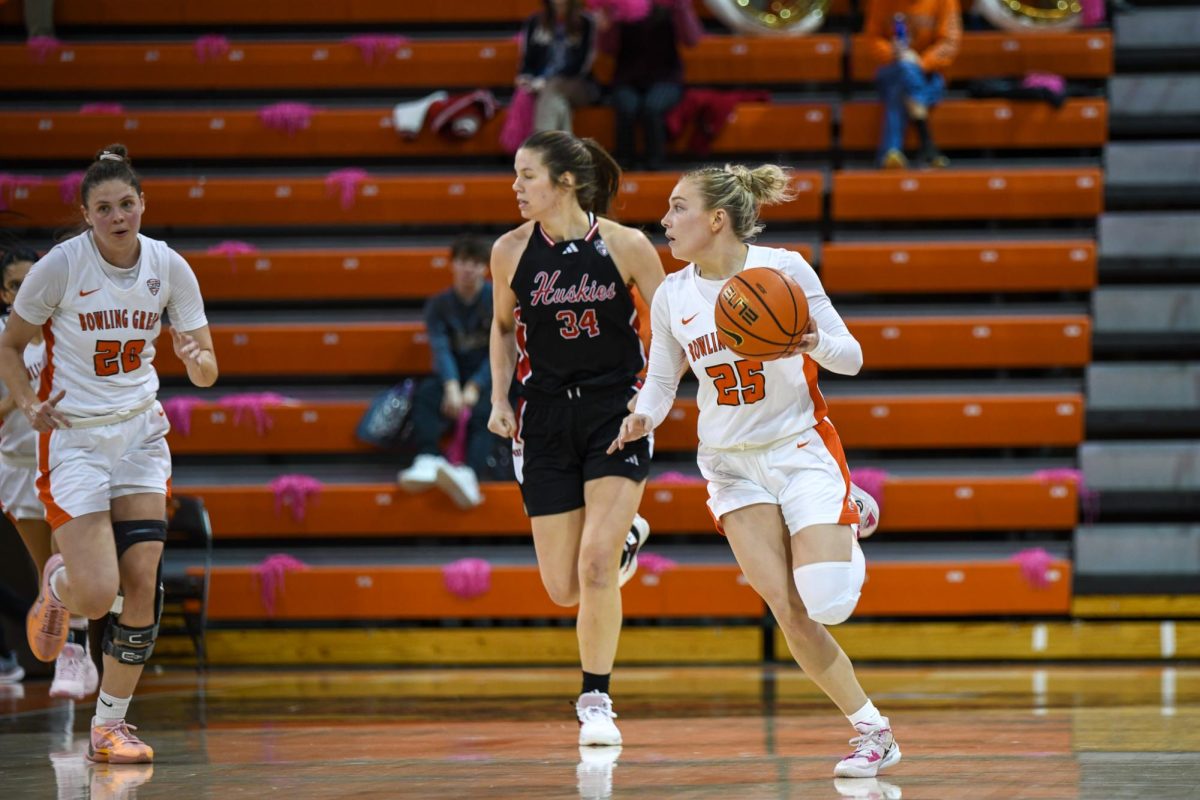 Bowling Green, OH - fifth year guard Lexi Fleming (25) taking the ball up the court at the Stroh Center in Bowling Green, Ohio.