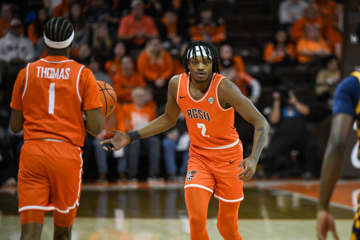 Bowling Green, OH - Falcons junior guard Javontae Campbell (2) handing the ball off to senior guard Trey Thomas (1) at the Stroh Center in Bowling Green, Ohio.