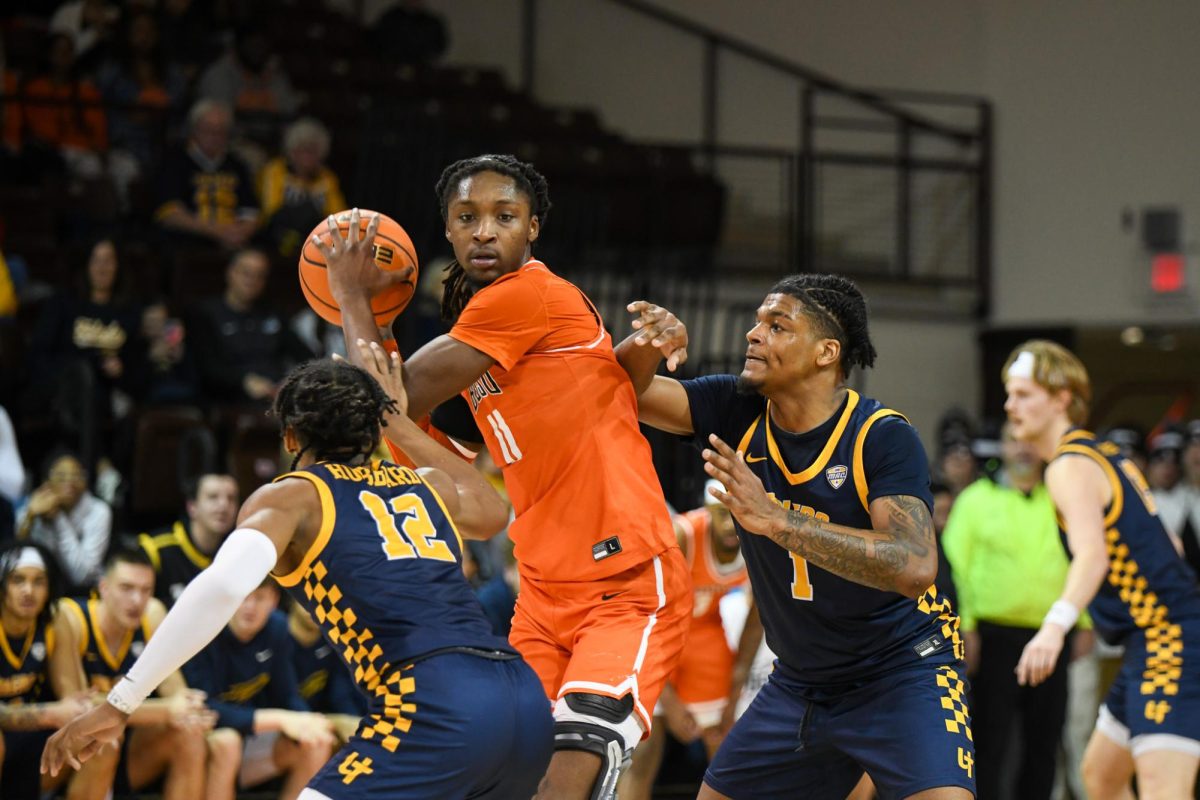 Bowling Green, OH - Falcons redshirt freshman forward Jamai Felt (11) fighting off two Rockets defenders looking for a pass down low at the Stroh Center in Bowling Green, Ohio.