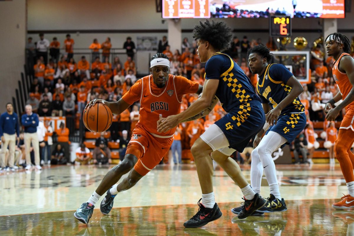 Bowling Green, OH - Falcons senior guard Trey Thomas (1) driving to the paint through the Rockets defense at the Stroh Center in Bowling Green, Ohio.