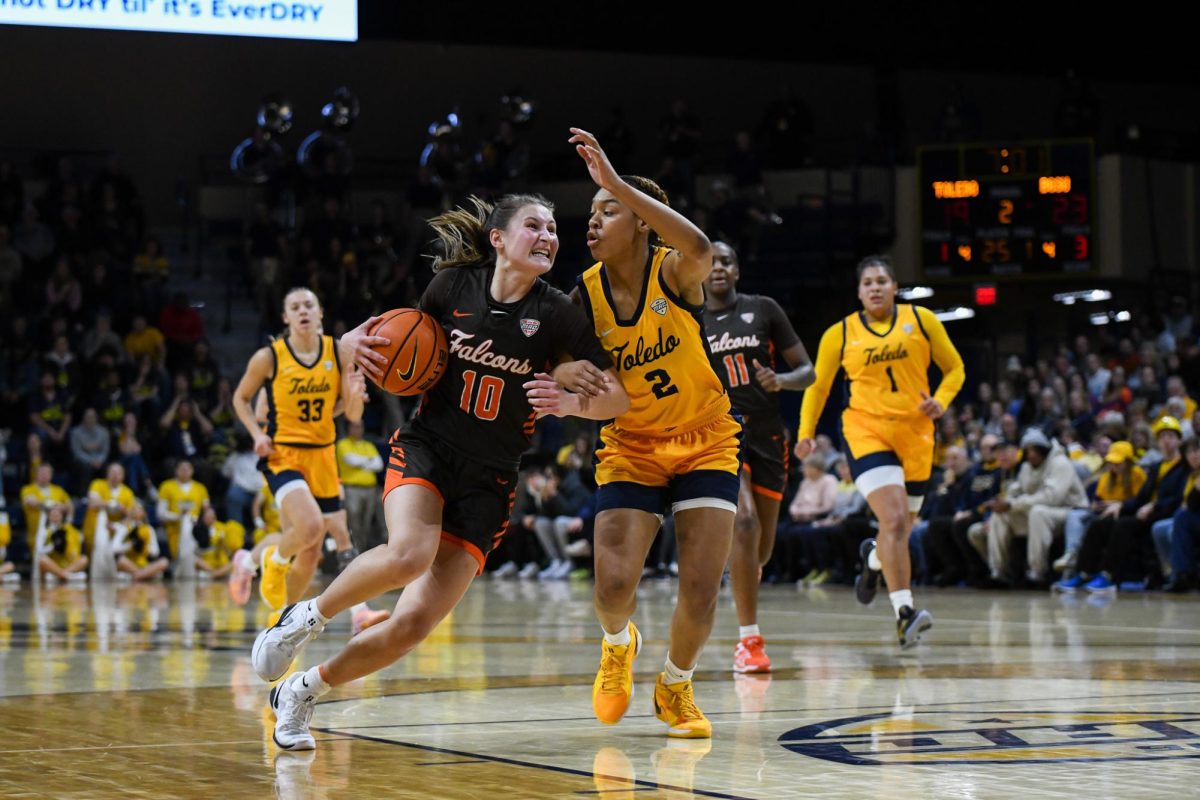 Toledo, OH - Falcons sophomore guard Paige Kohler (10) driving to the hoop through the Rockets defense at Savage Arena in Toledo, Ohio.