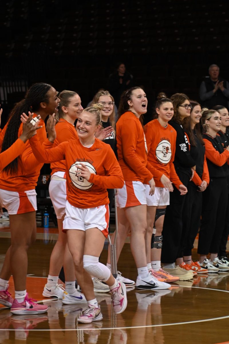 Bowling Green, OH - Lexi Fleming (25) high-fives her teammates at the start of the game in Bowling Green, Ohio.