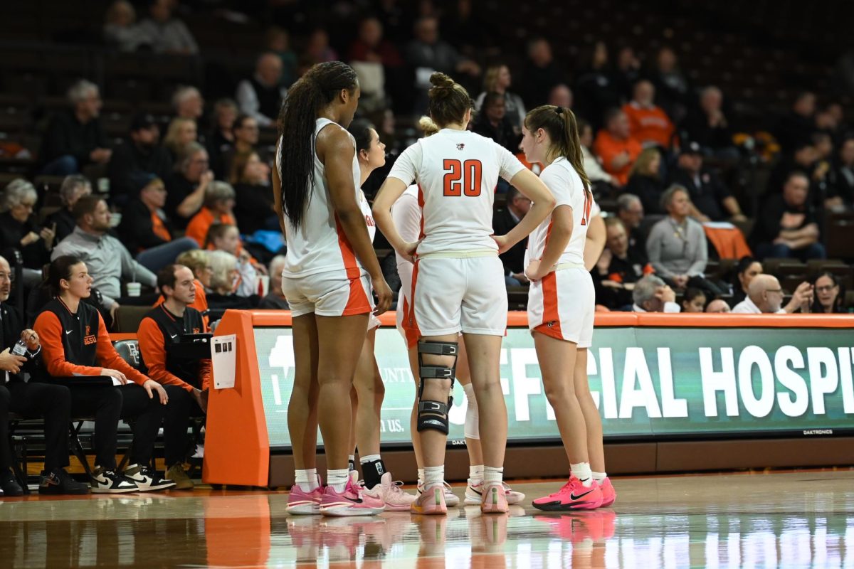 Bowling Green, OH - The five BGSU players on the court huddle up while waiting for the refs decision in Bowling Green, Ohio.