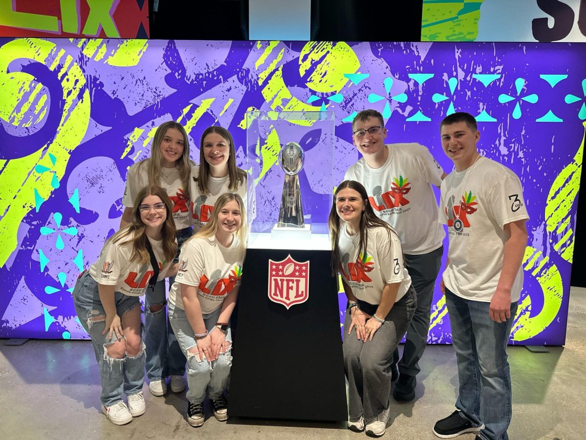 Students on the trip pose with the Lombardi trophy.