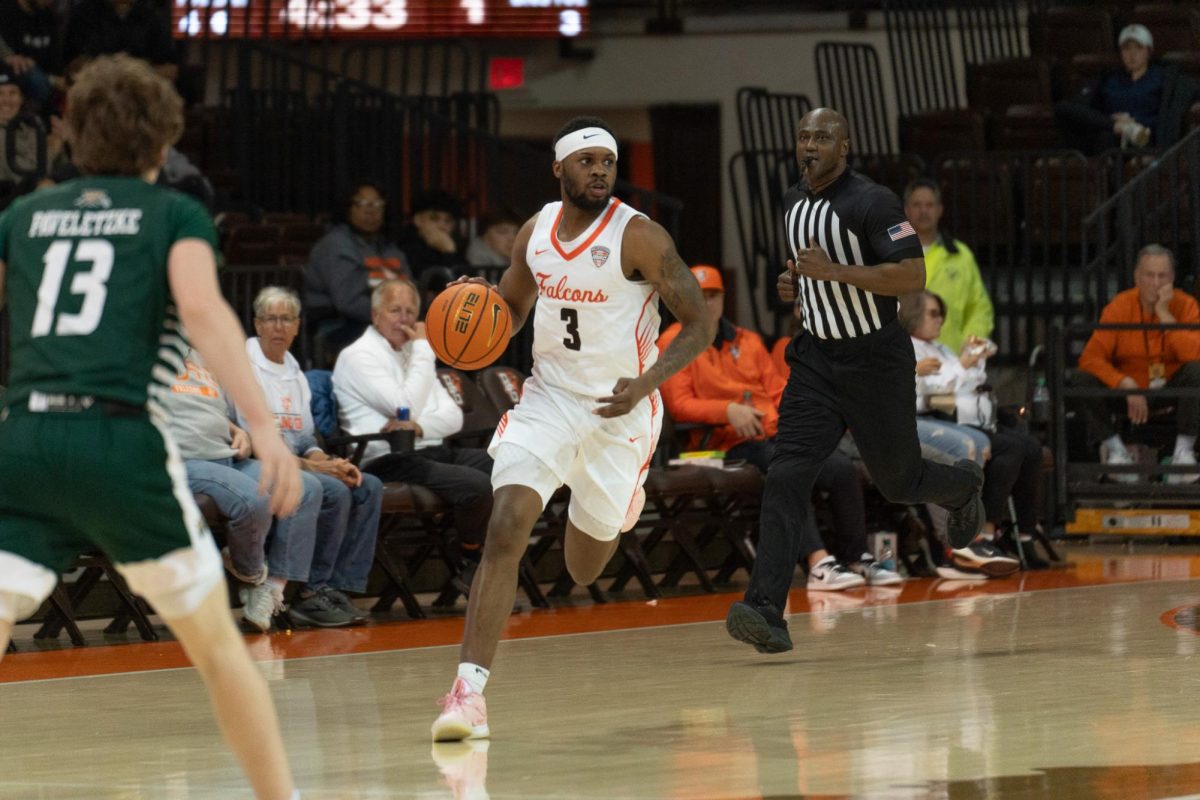 Bowling Green, OH- Falcons senior guard DaJion Humphrey (3) takes the ball past the BGSU logo at the Stroh Center in Bowling Green, Ohio.