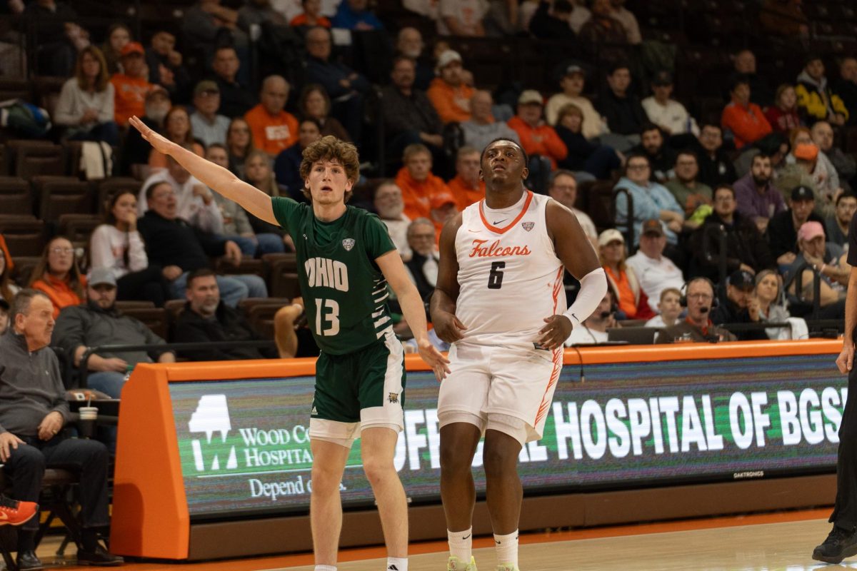 Bowling Green, OH- Falcons senior forward Marcus Johnson (6) and Bobcats guard Jackson Paveletzke (13) watch the shot at the Stroh Center in Bowling Green, Ohio.