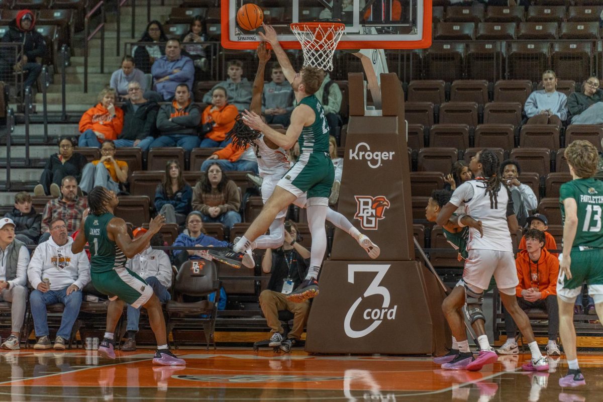 Bowling Green, OH- Falcons junior guard Javontae Campbell (2) fights for a rebound with Bobcats forward AJ Clayton (23) at the Stroh Center in Bowling Green, Ohio