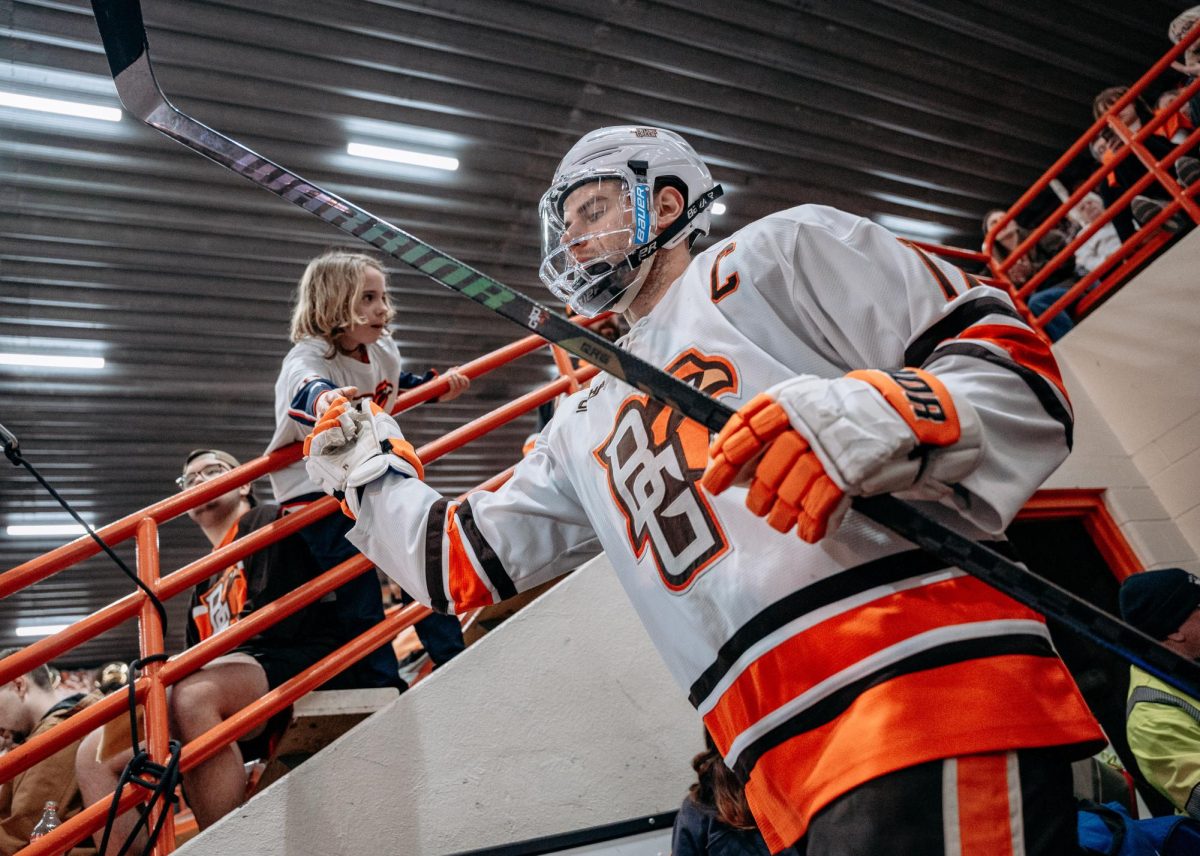 Bowling Green, OH – Falcons graduate forward Ethan Scardina (17) fist bumps a fan at Slater Family Ice Arena in Bowling Green, Ohio.