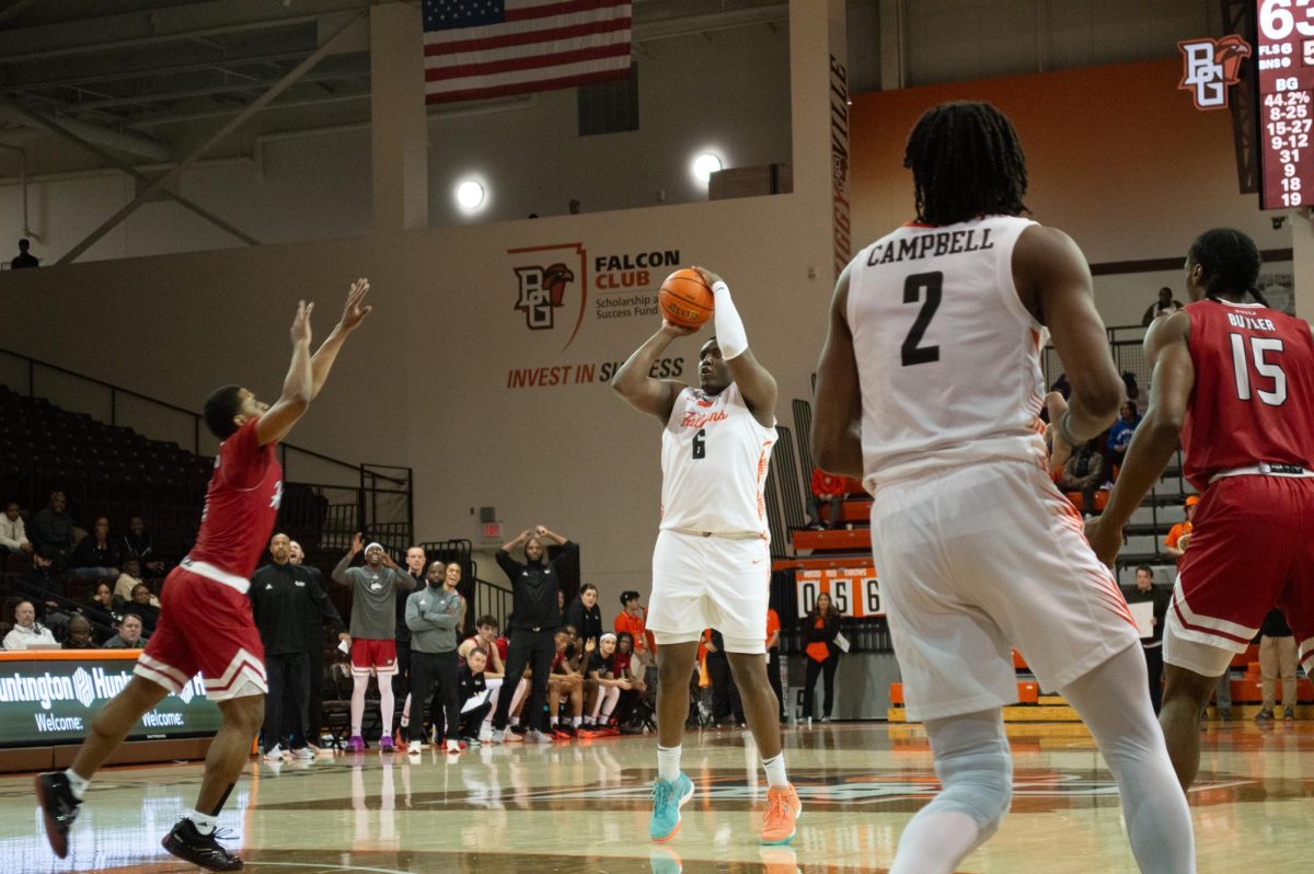 Bowling Green, OH - Falcons senior guard Marcus Johnson (6) pulling up for a three pointer at the Stroh Center in Bowling Green, Ohio.