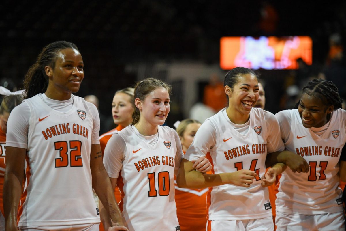 Bowling Green, OH - Falcons fifth year forward Erika Porter (32), sophomore guard Paige Kohler (10), sophomore guard Keiryn McGuff (14) and sophomore forward Taya Ellis (11) celebrating their win over the Chippewas at the Stroh Center in Bowling Green, Ohio.