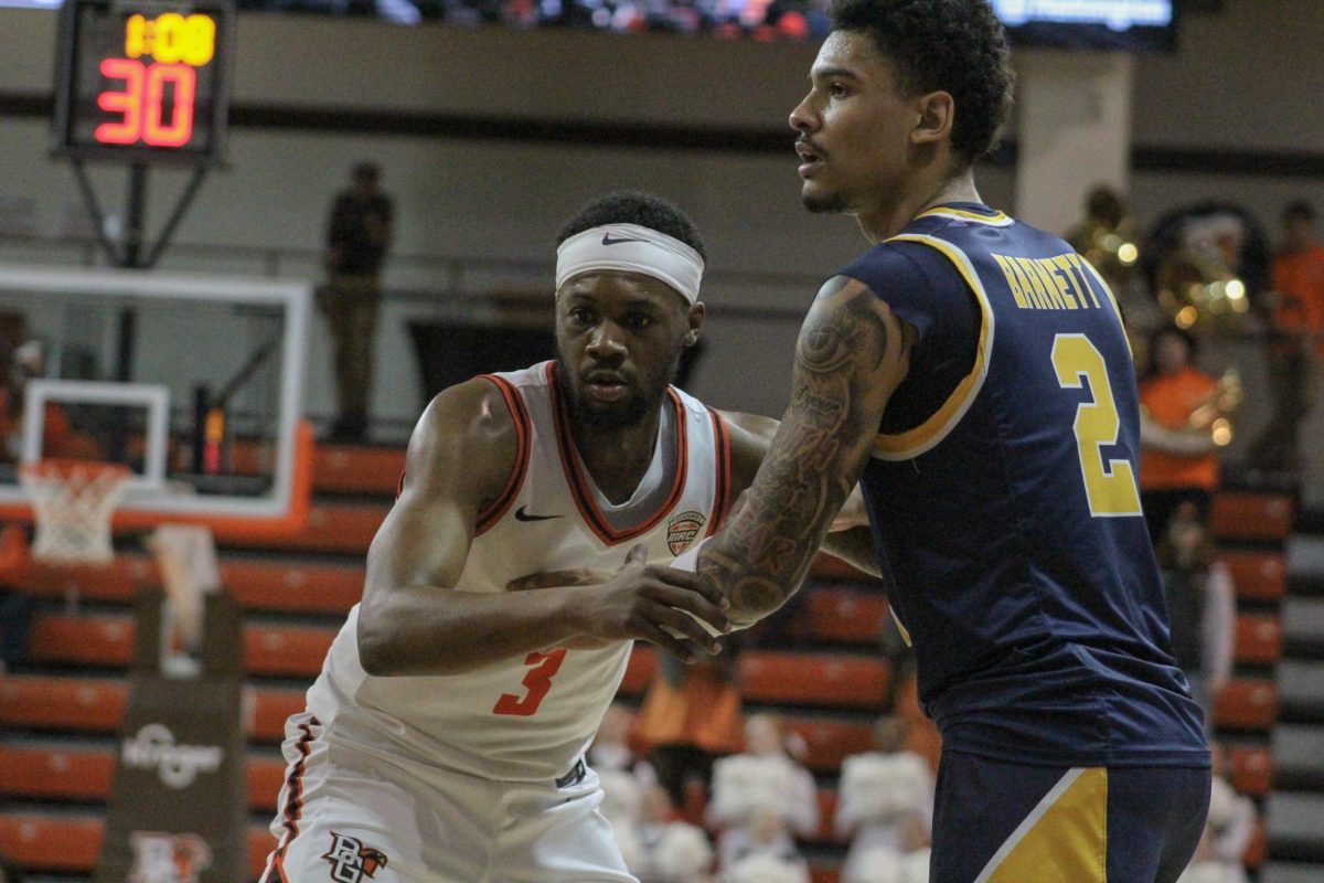 Bowling Green, OH - Falcons senior guard DaJion Humphrey (3) being guarded by KSU defense at the Stroh Center in Bowling Green, Ohio.