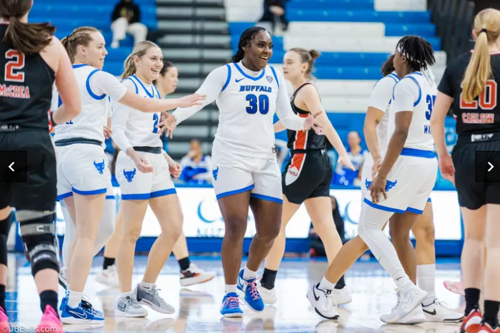 Buffalo senior forward Jordyn Beaty high-fiving her teammates during their game against Northern Illinois