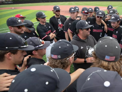 Northern Illinois second-year head coach Ryan Copeland surrounded by his players in a huddle