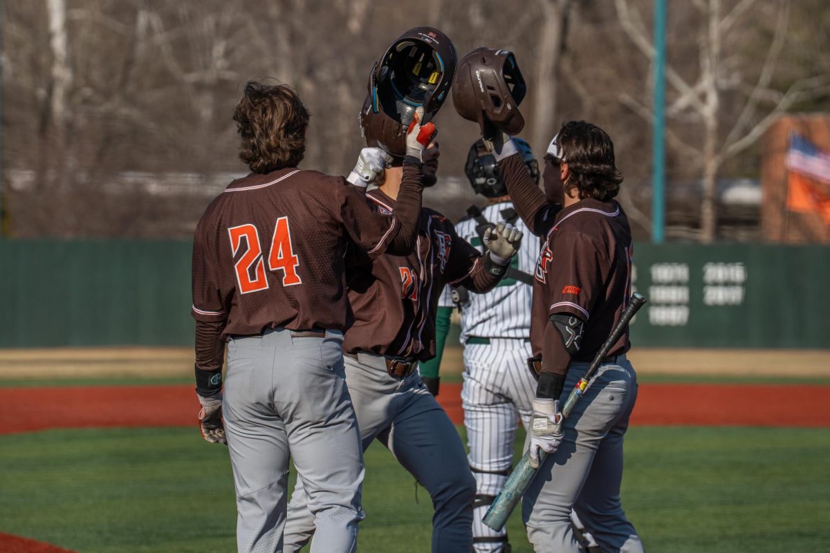 Athens, OH- Falcon teammates meet junior second baseman Sam Seidel (21) at home after his home run at Bob Wren Stadium in Athens, Ohio.