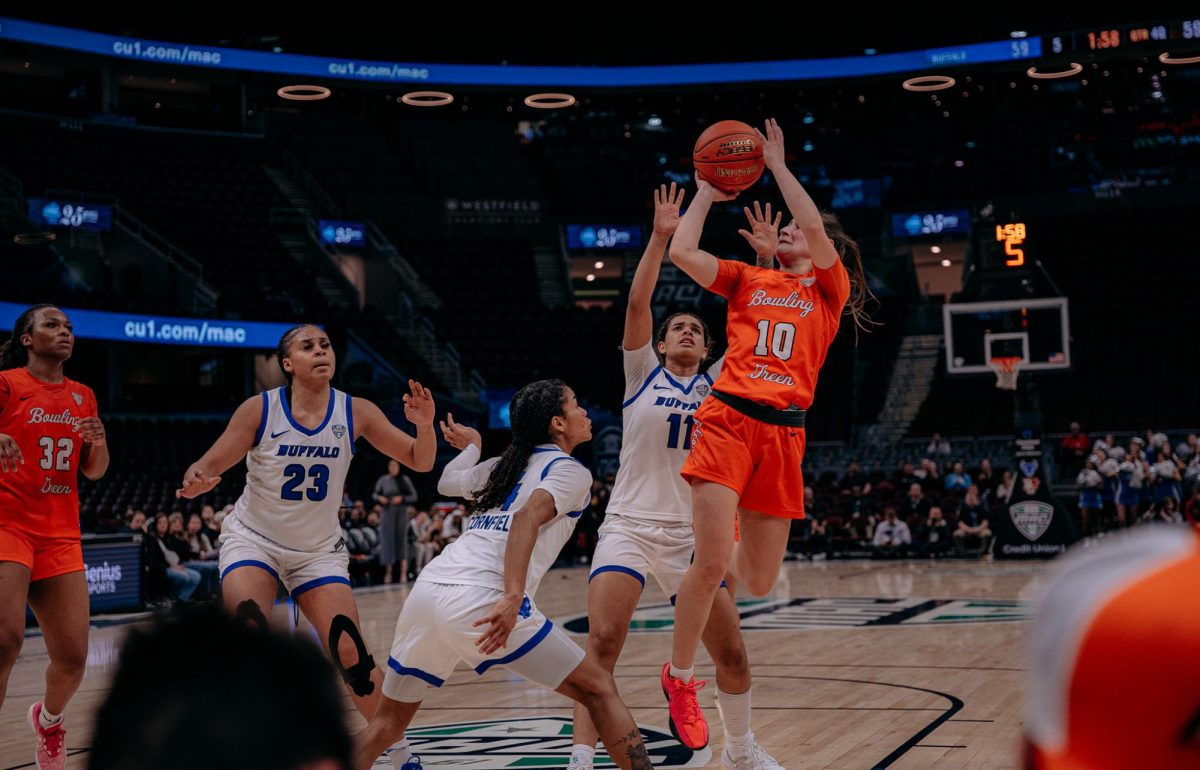 Cleveland, OH - Falcons sophomore guard Paige Kohler (10) takes a shot against multiple Bulls defenders at Rocket Arena in Cleveland, Ohio.