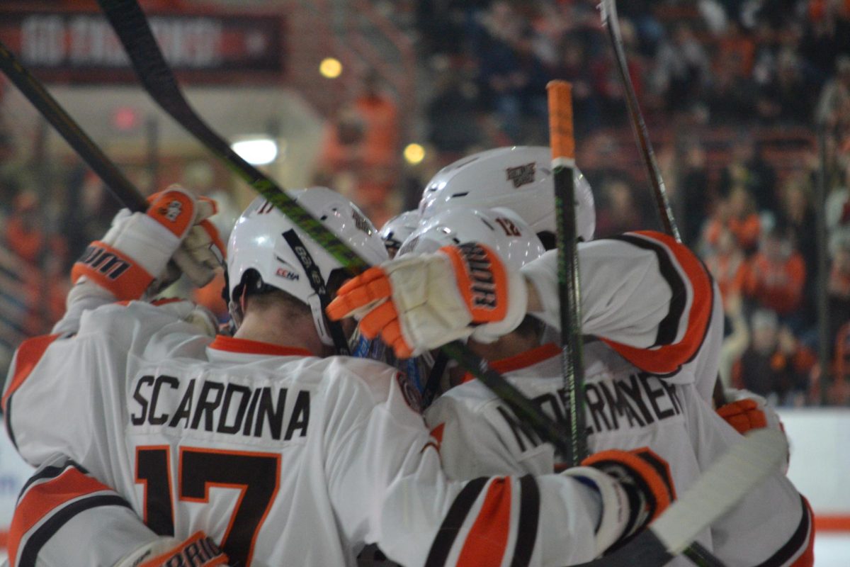 Bowling Green, OH- Falcons redshirt senior forward Jackson Niedermayer (12) and graduate forward Ethan Scardina (17) celebrating a goal at the Slater Family Ice Arena.