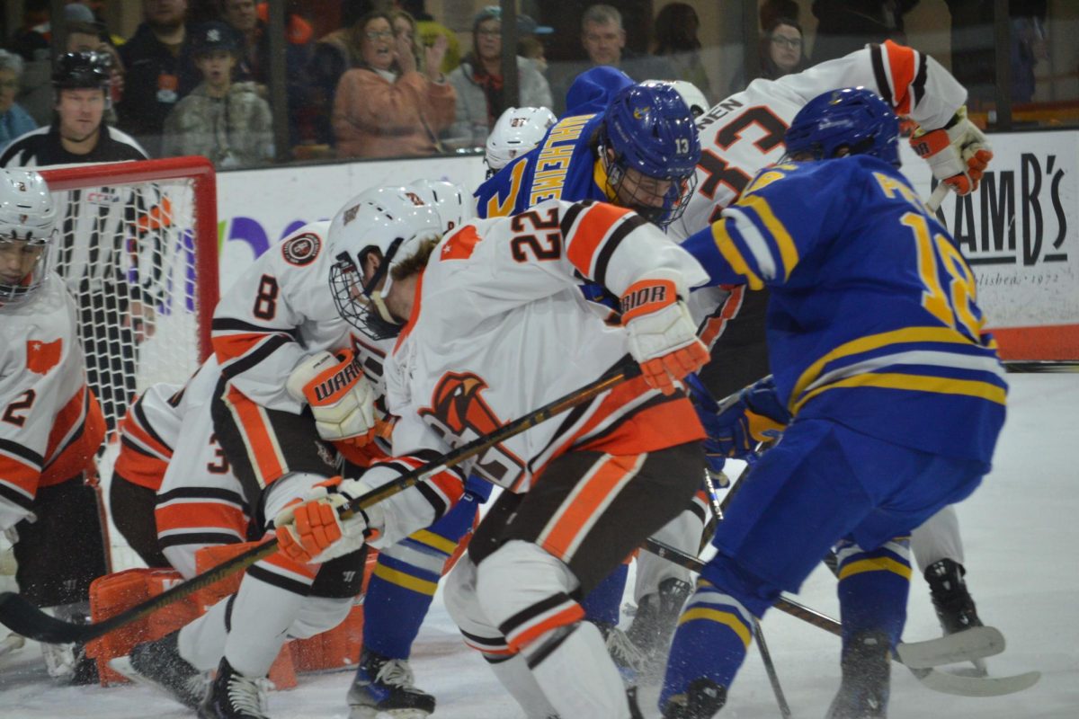 Bowling Green, OH- Falcons graduate forward Ville Immonen (33) and senior forward Owen Ozar (22) fighting to keep the puck out of the home net at the Slater Family Ice Arena in Bowling Green, Ohio.