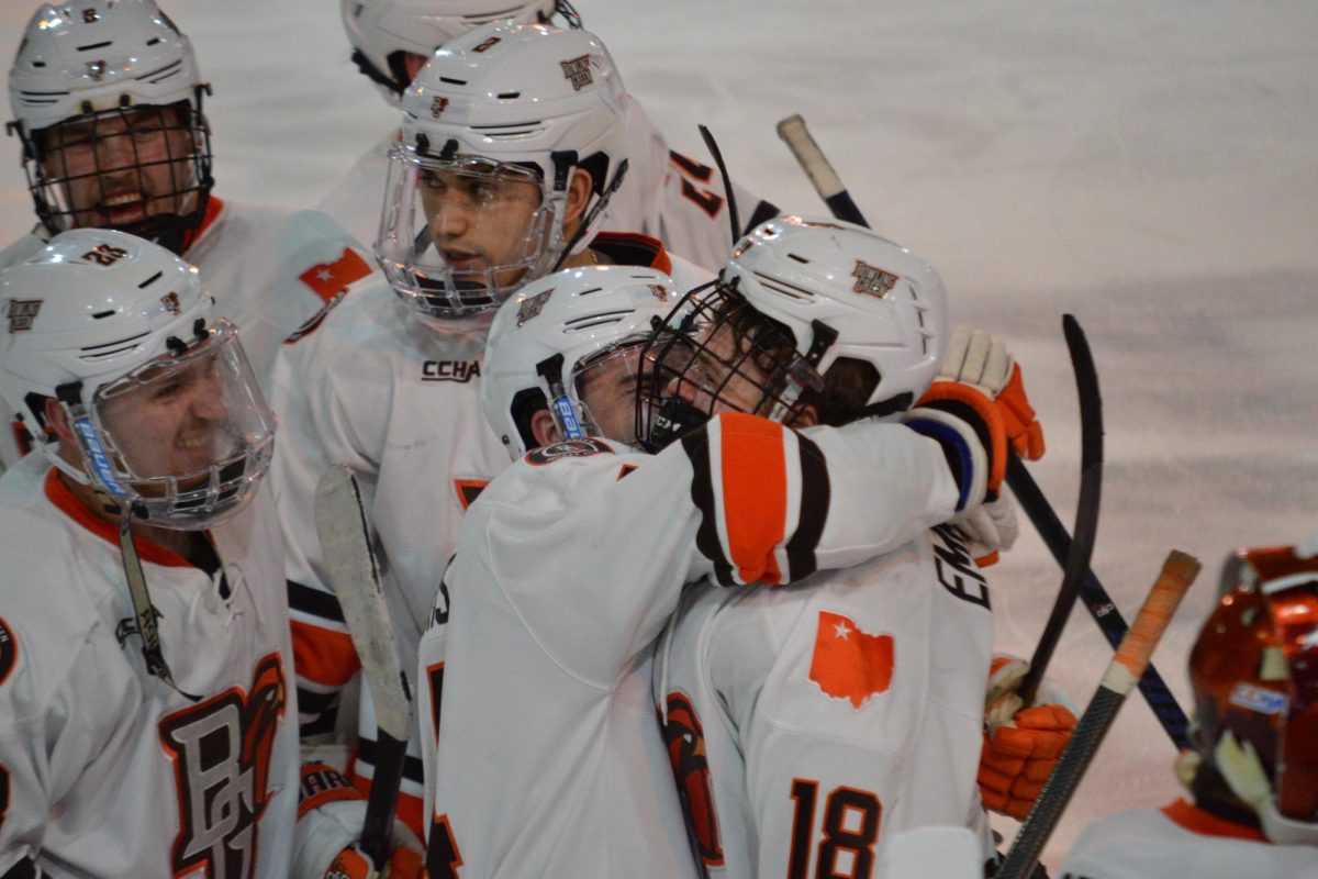 Bowling Green, OH- Falcons junior defense Dalton Norris (14) and junior forward Quinn Emerson (18) amongst other Falcons celebrating the BGSU overtime win at the Slater Family Ice Arena in Bowling Green, Ohio.