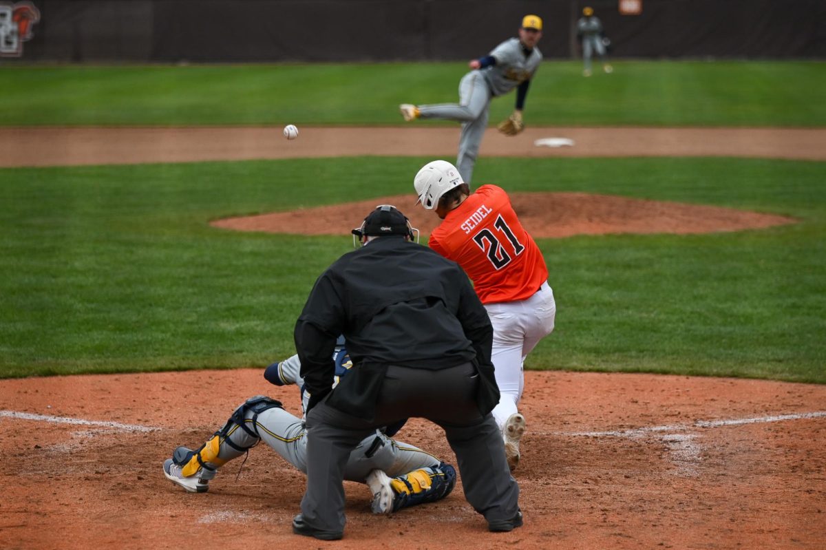 Bowling Green, OH - Falcons junior infielder Sam Seidel (21) driving the ball to the outfield at Steller Field in Bowling Green, Ohio.