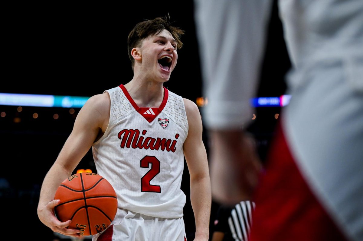 Cleveland, OH - Redhawks sophomore guard Evan Isparo (2) celebrating the victory with his bench to take them to the MAC Basketball Championship at Rocket Arena in Cleveland, Ohio.