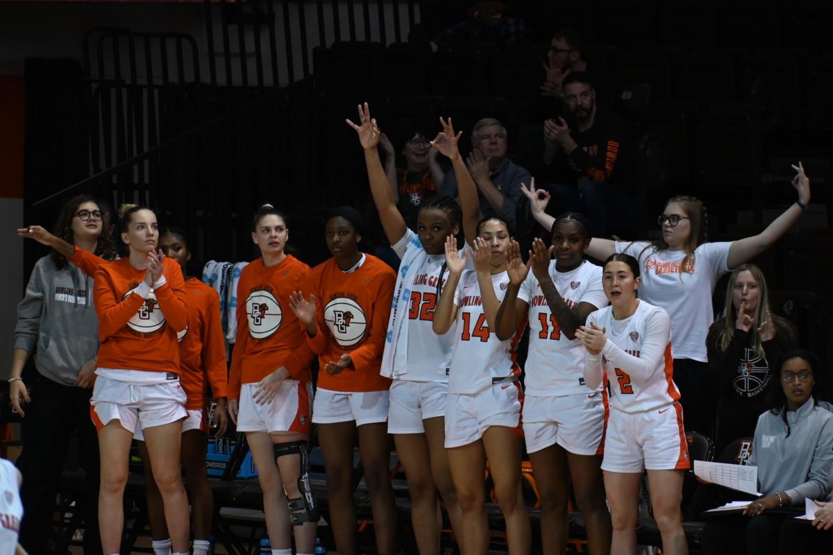 Bowling Green, OH - The team celebrates another 3-pointer made by Lexi Fleming (25) at the Stroh Center in Bowling Green, Ohio.