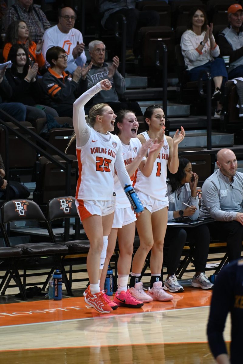 Bowling Green, OH - Lexi Fleming (25), Paige Kohler (10), and Amy Velasco (1) celebrate the win against Kent State at the Stroh Center in Bowling Green, Ohio.