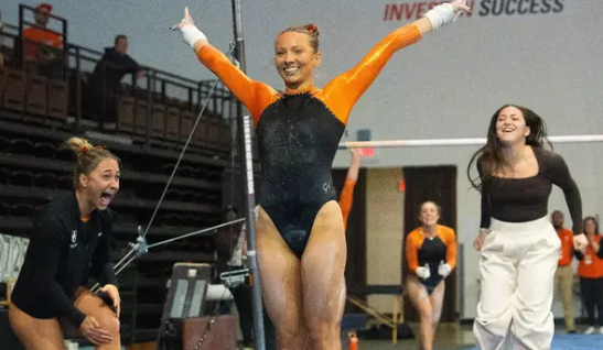 Bowling Green senior Kennady Kreinbrink finishing an uneven bar routine.