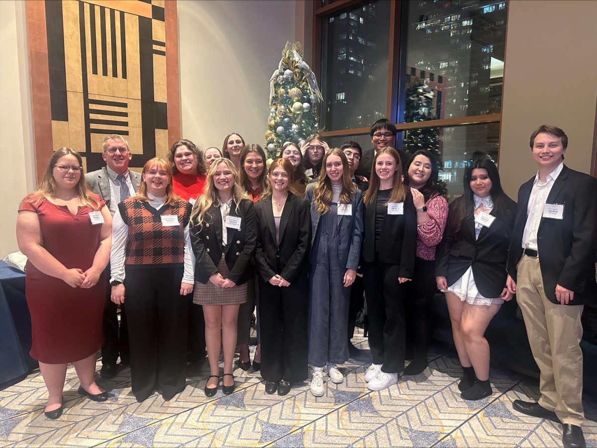 The students of IRO represent, pictured with Dr. Simon in 2023, raised money for a memorial tree in Dr. Simon's honor (photo via Elyse Adrian).