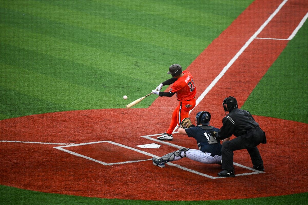 Avon, OH - Falcons junior second baseman Sam Seidel (21) making contact with a pitch from the Rockets at Crushers Stadium in Avon, Ohio.