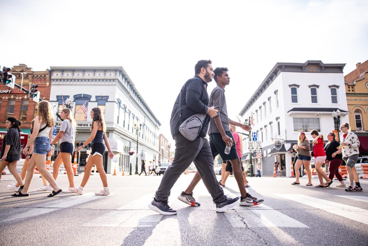 Bowling Green, OH - Students walk across the street at Rally BG on Main in Bowling Green, Ohio.