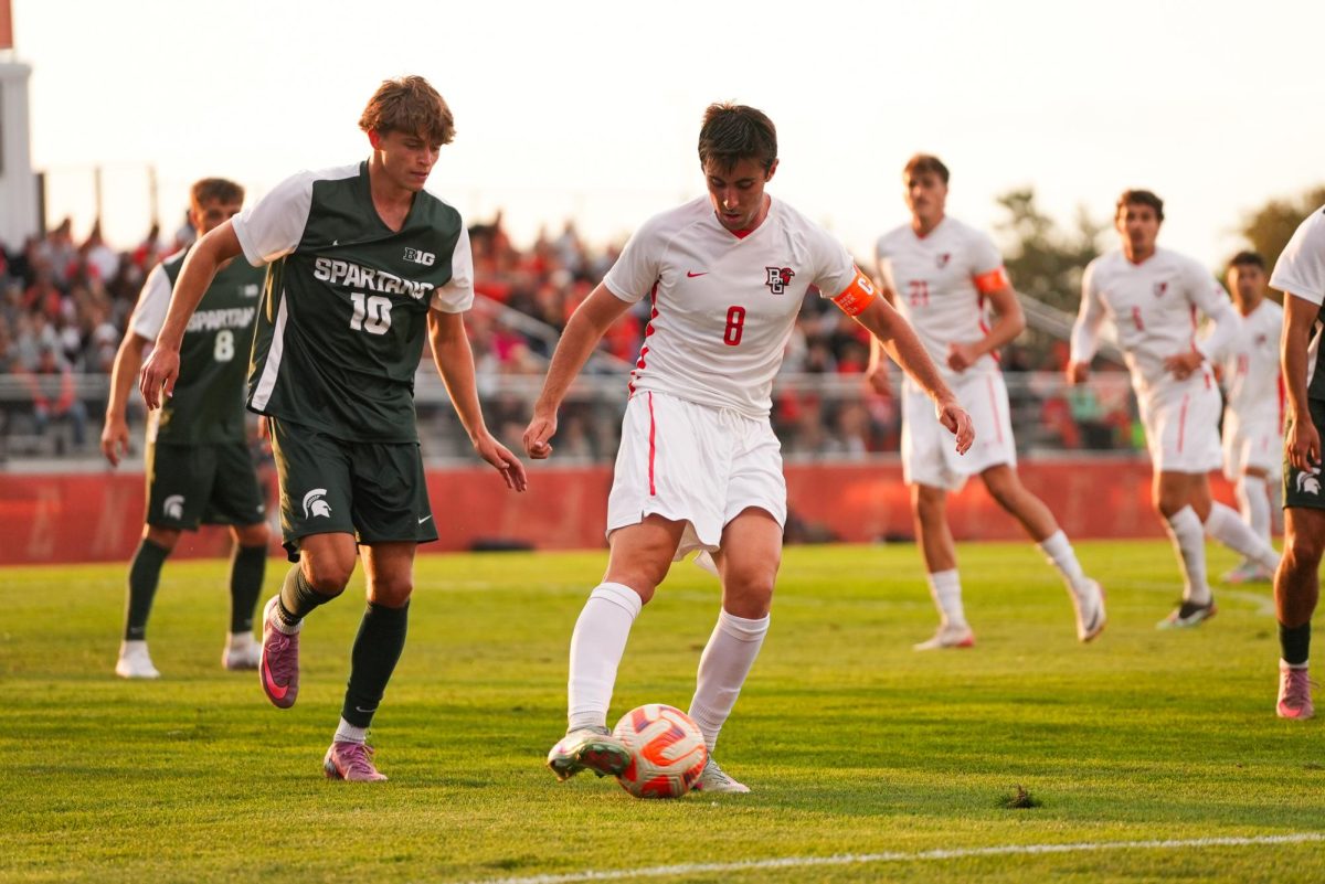 Bowling Green, OH - Falcons senior midfielder Andrew Shaffer (8) works the ball past the Spartans at Cochrane Stadium in Bowling Green, Ohio.