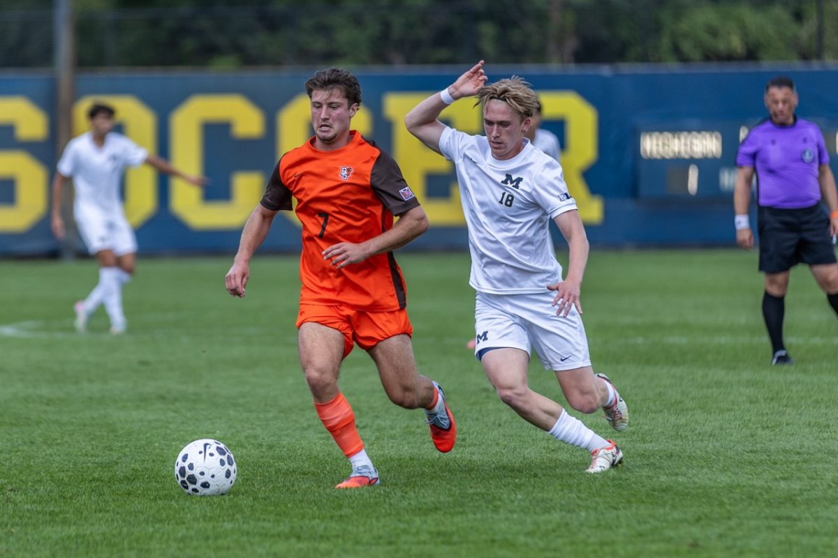 Ann Arbor, MI - Falcons sophomore midfielder Ryko Bodurov (7) evades the Wolverine defense at UM Soccer Stadium in Ann Arbor, Michigan