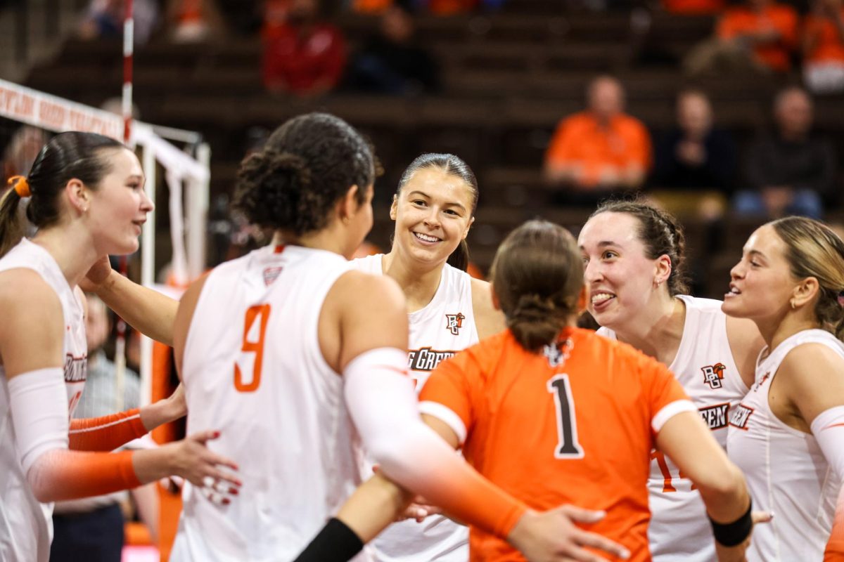 Bowling Green, OH - Falcons senior middle blocker Jessica Andrews (7) celebrates scoring a point against the Cardinals at the Stroh Center in Bowling Green, Ohio.
